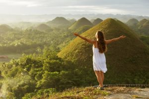 Woman,Doing,Yoga,In,The,Chocolate,Hills.,Bohol,,Philippines